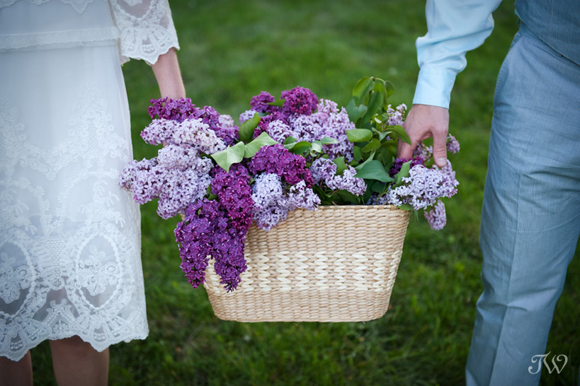 Calgary-engagement-photographs-bride-groom-holding-lilacs