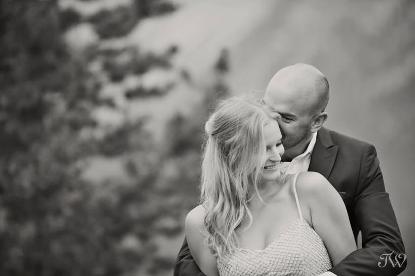 Caitie and Mark embrace at their Spray Lakes engagement session captured by Tara Whittaker Photography