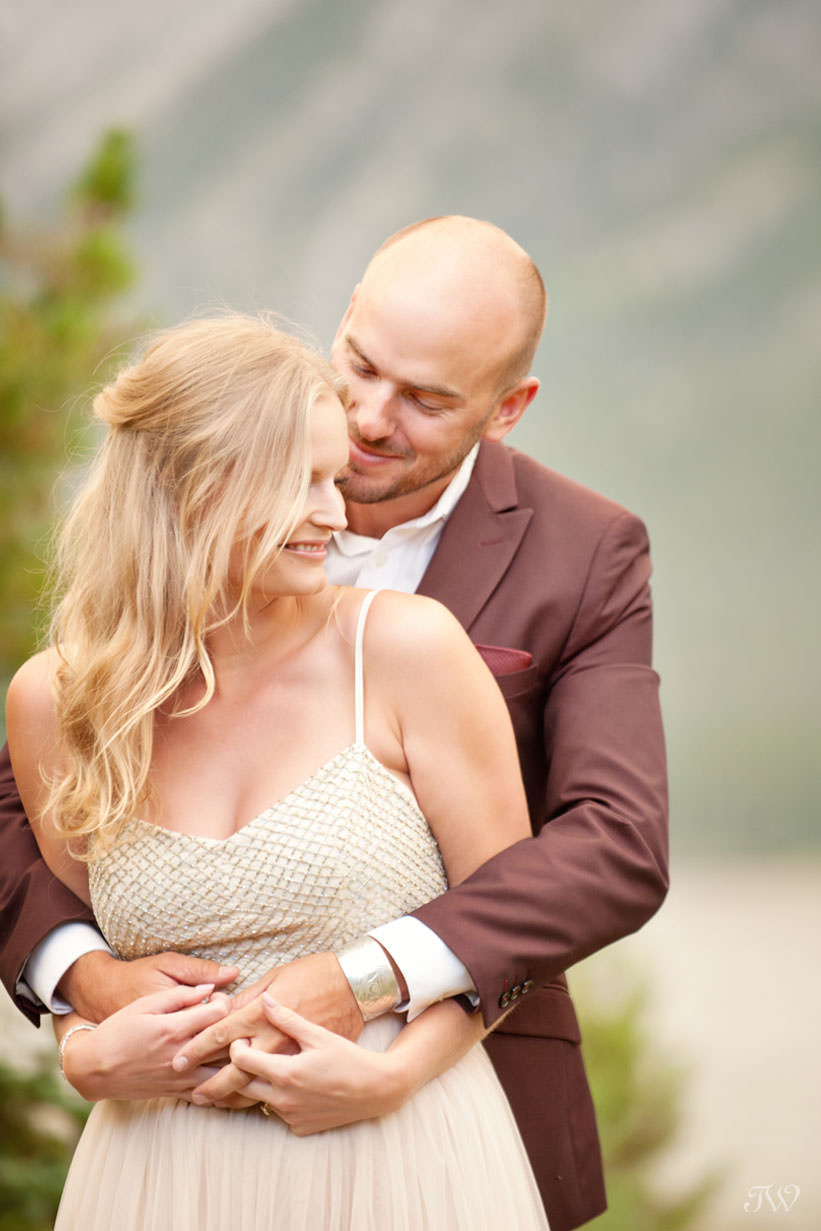 Bride and groom embrace at their Spray Lakes engagement session captured by Tara Whittaker Photography